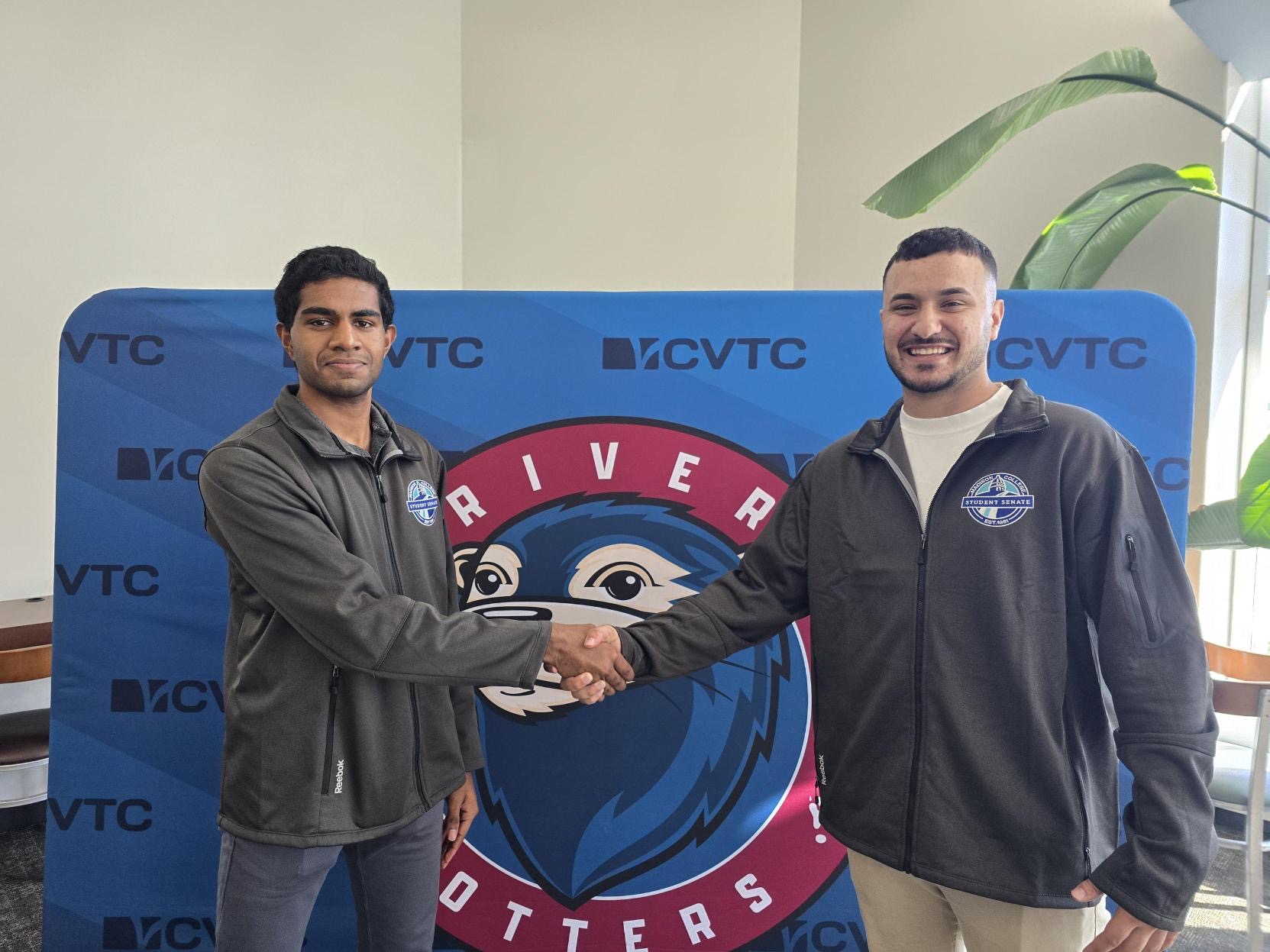 Handshake in front of CVTC banner