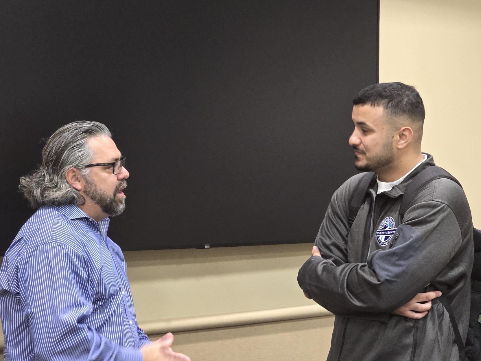 Furkan speaking with a participant during the meeting