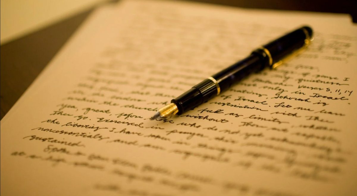 Notebook and pen representing writing self-assessment