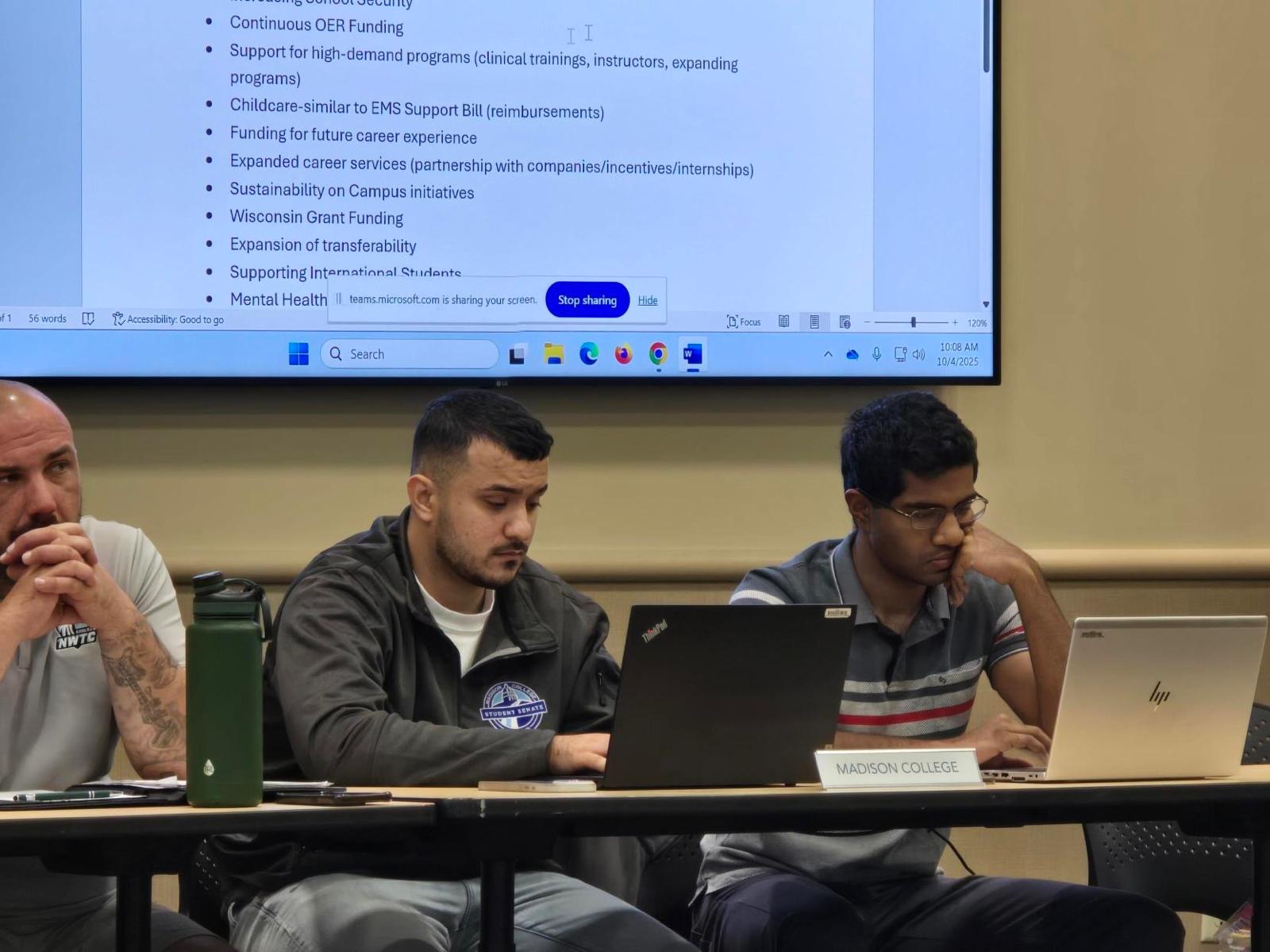 Working session during the meeting with laptops and shared agenda on the screen