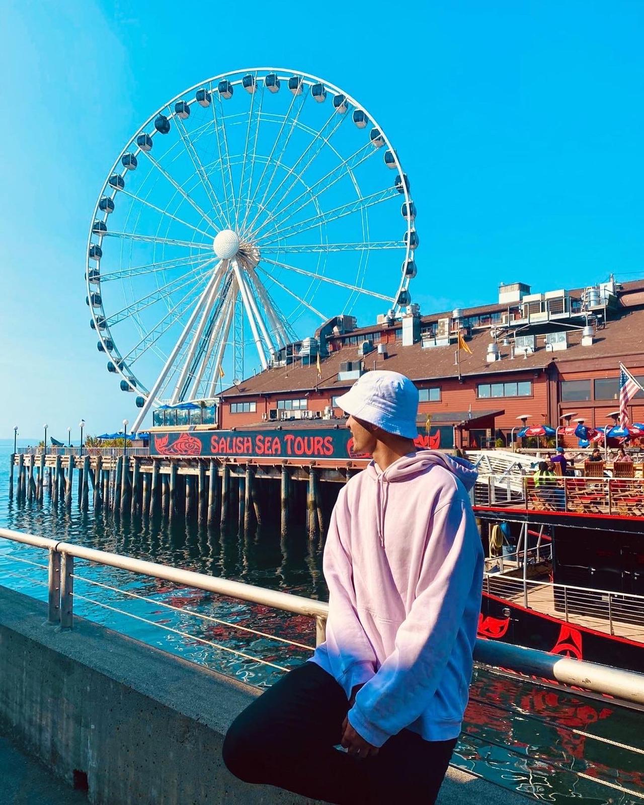 Smiling in front of a famous sculpture in downtown Seattle