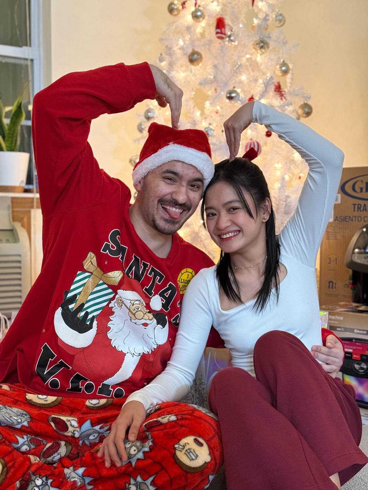Wearing matching Christmas pajamas and celebrating