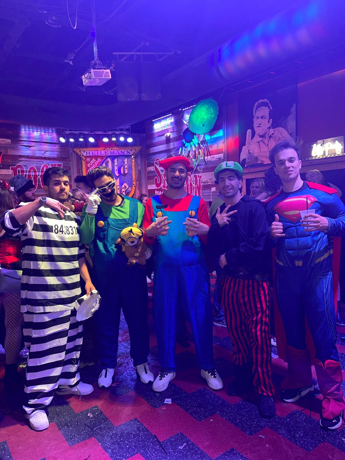 Group photo in Halloween costumes at a party