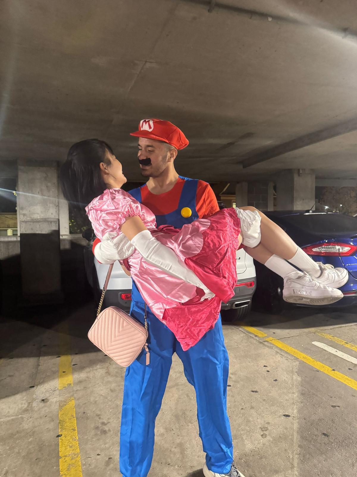 Mario and Princess Peach costume in parking lot