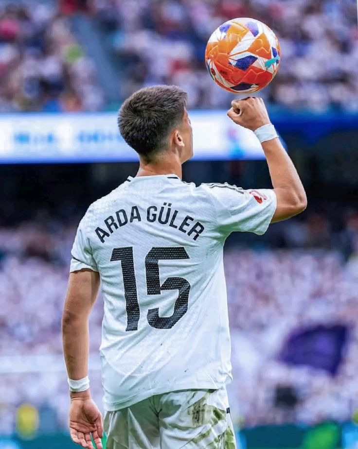 Arda Güler holding the ball in Real Madrid kit